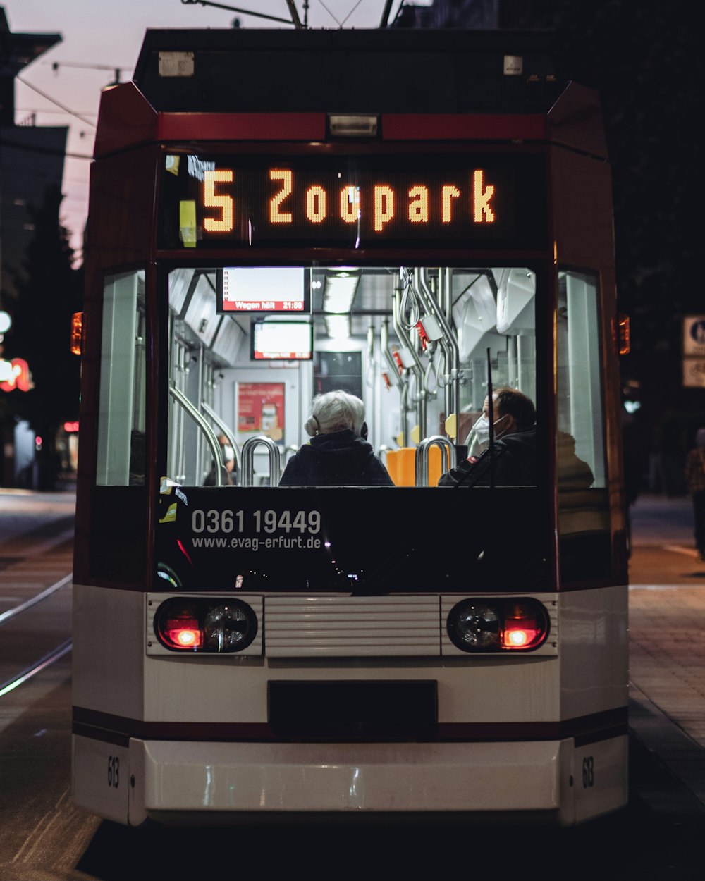 people in white and black bus during night time