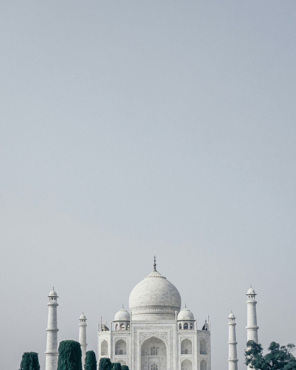 white concrete building under white sky during daytime