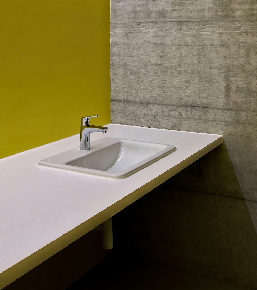 white ceramic sink with stainless steel faucet