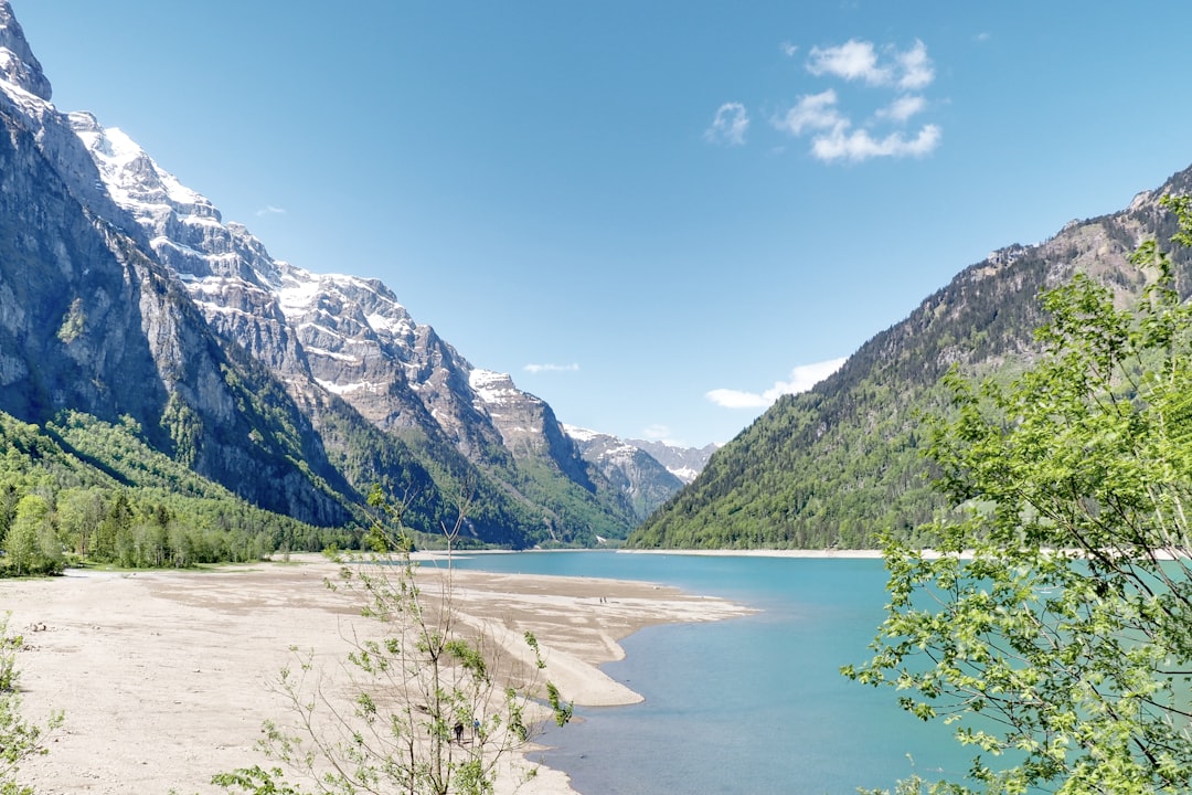 lake in the middle of mountains during daytime