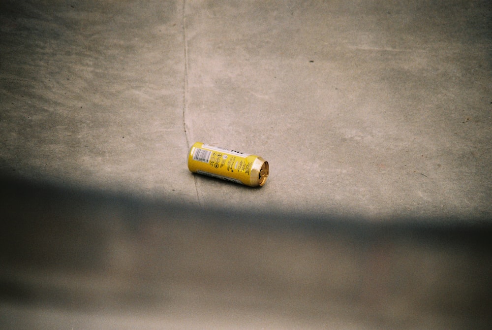 yellow plastic bottle on gray textile