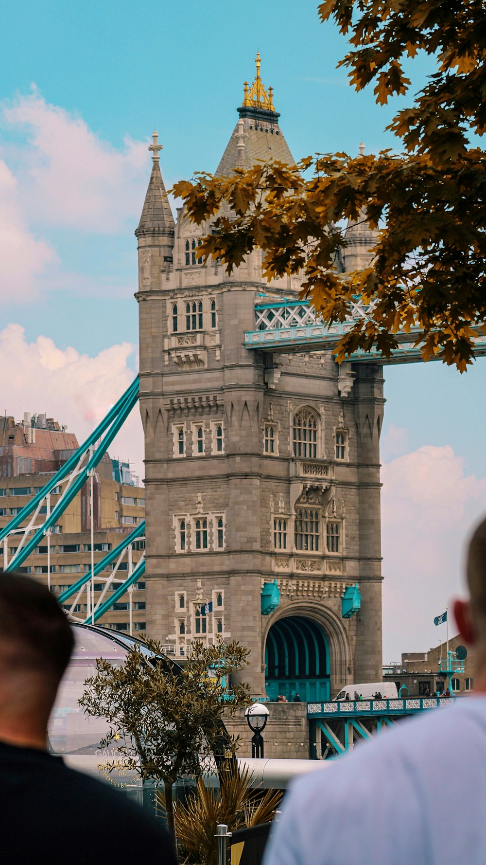 people walking on bridge near brown concrete building during daytime