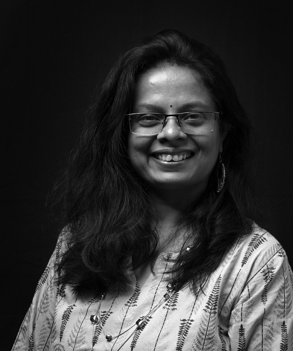 woman in white and black shirt wearing eyeglasses