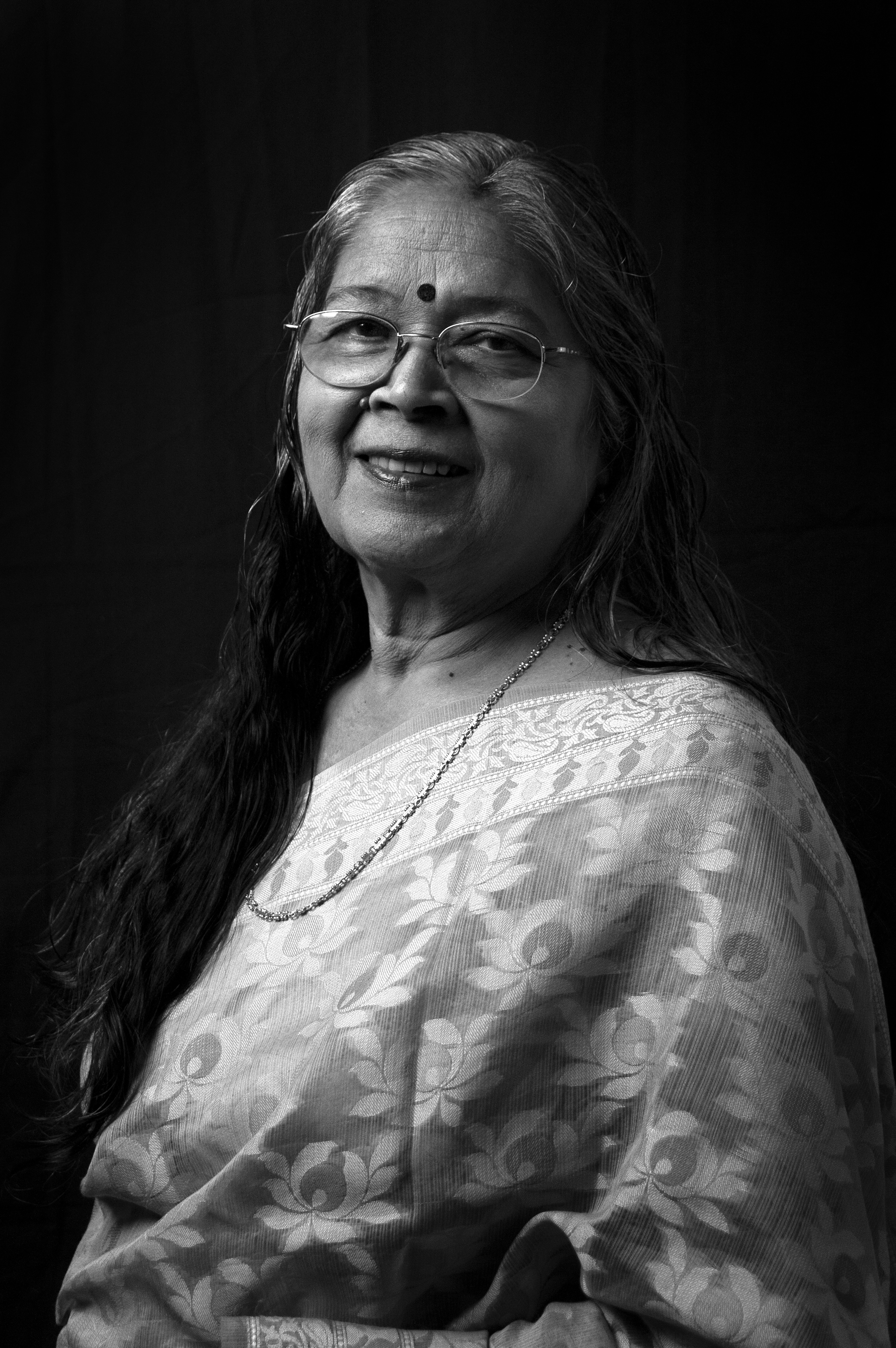 Portrait of a smiling Indian woman with glasses