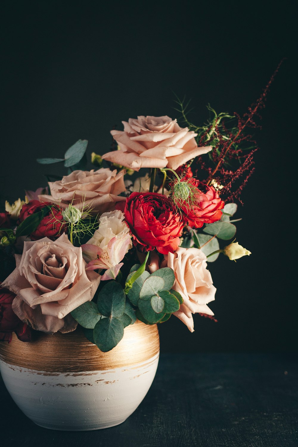 pink roses in white ceramic vase