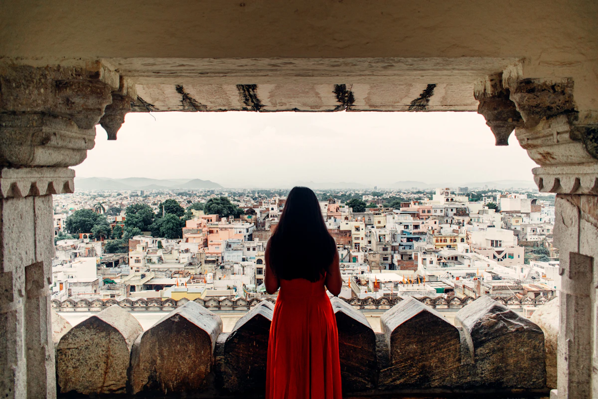 A person standing on a rooftop in an old city