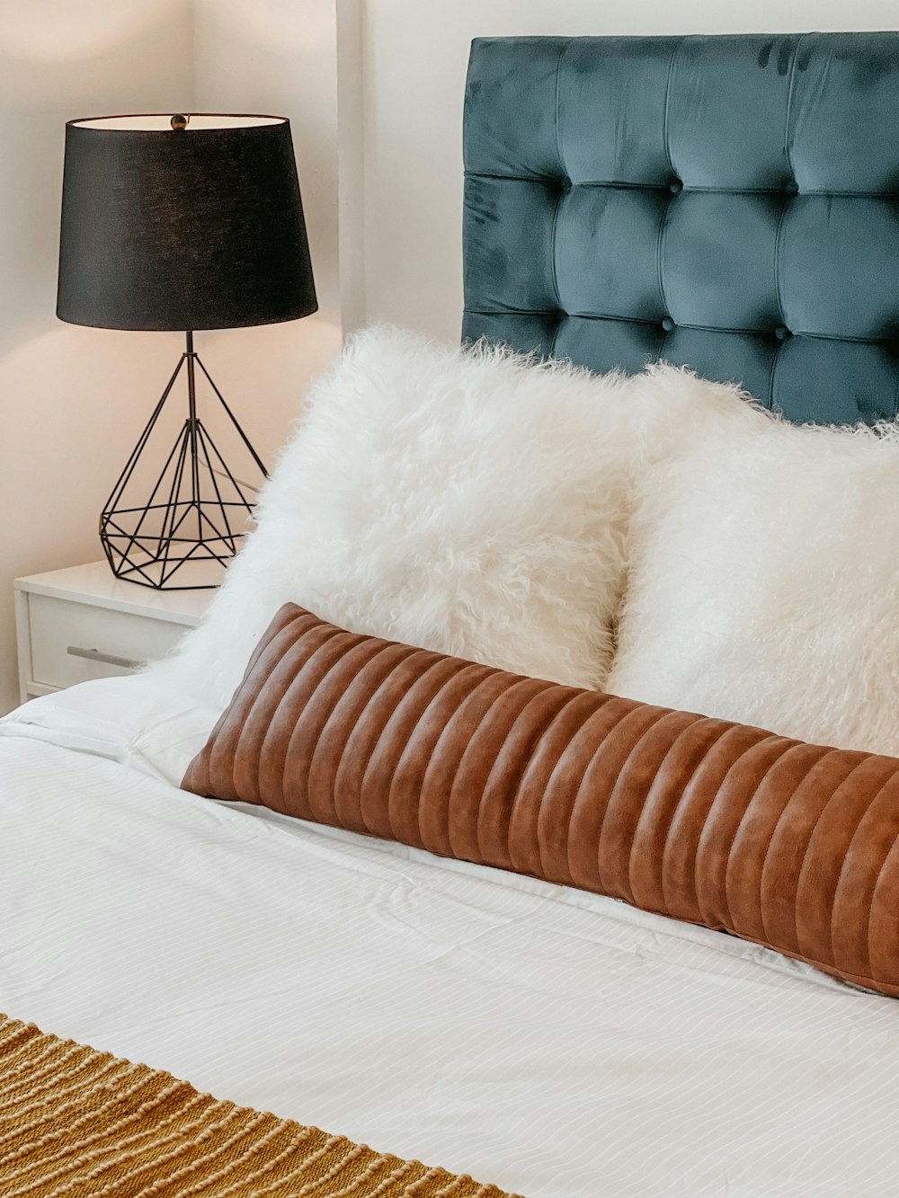 white fur textile on white bed