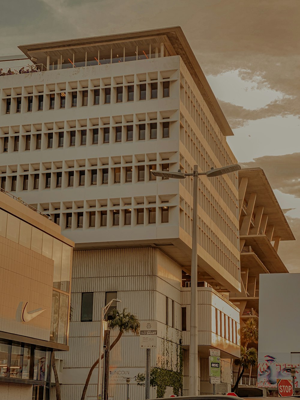 white concrete building under white clouds during daytime