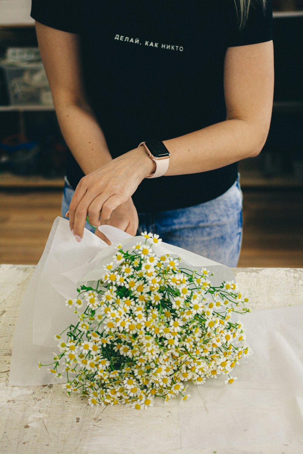 person holding white and yellow flower bouquet