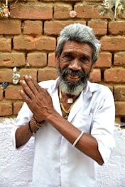 man in white button up shirt wearing gold ring
