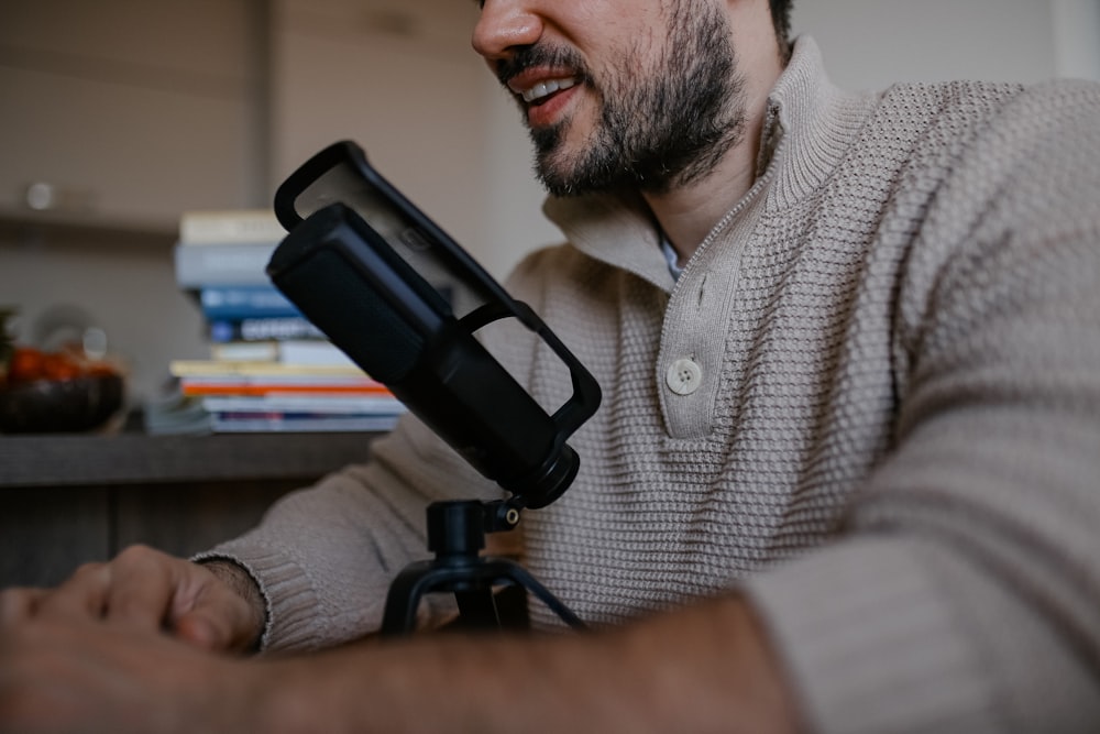 man in white and black checkered button up shirt holding black microphone