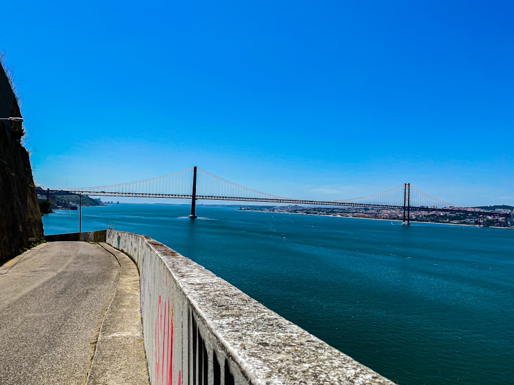 brown wooden bridge over blue sea under blue sky during daytime