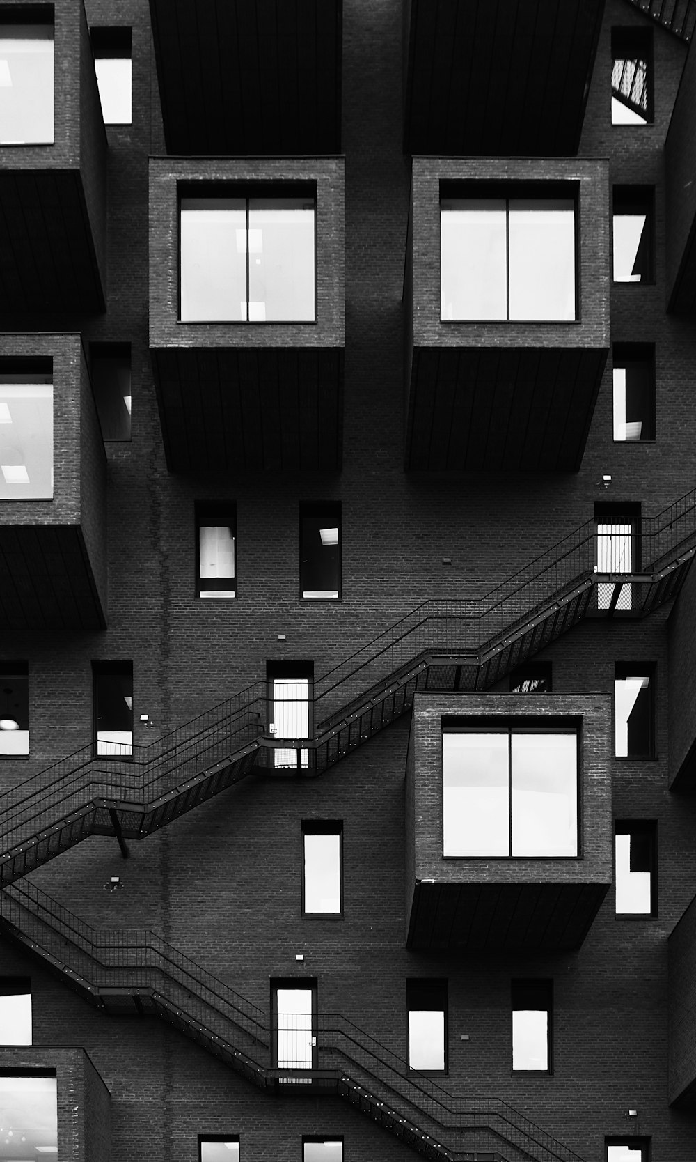 grayscale photo of building with windows