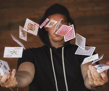 woman in black and white crew neck t-shirt holding playing cards