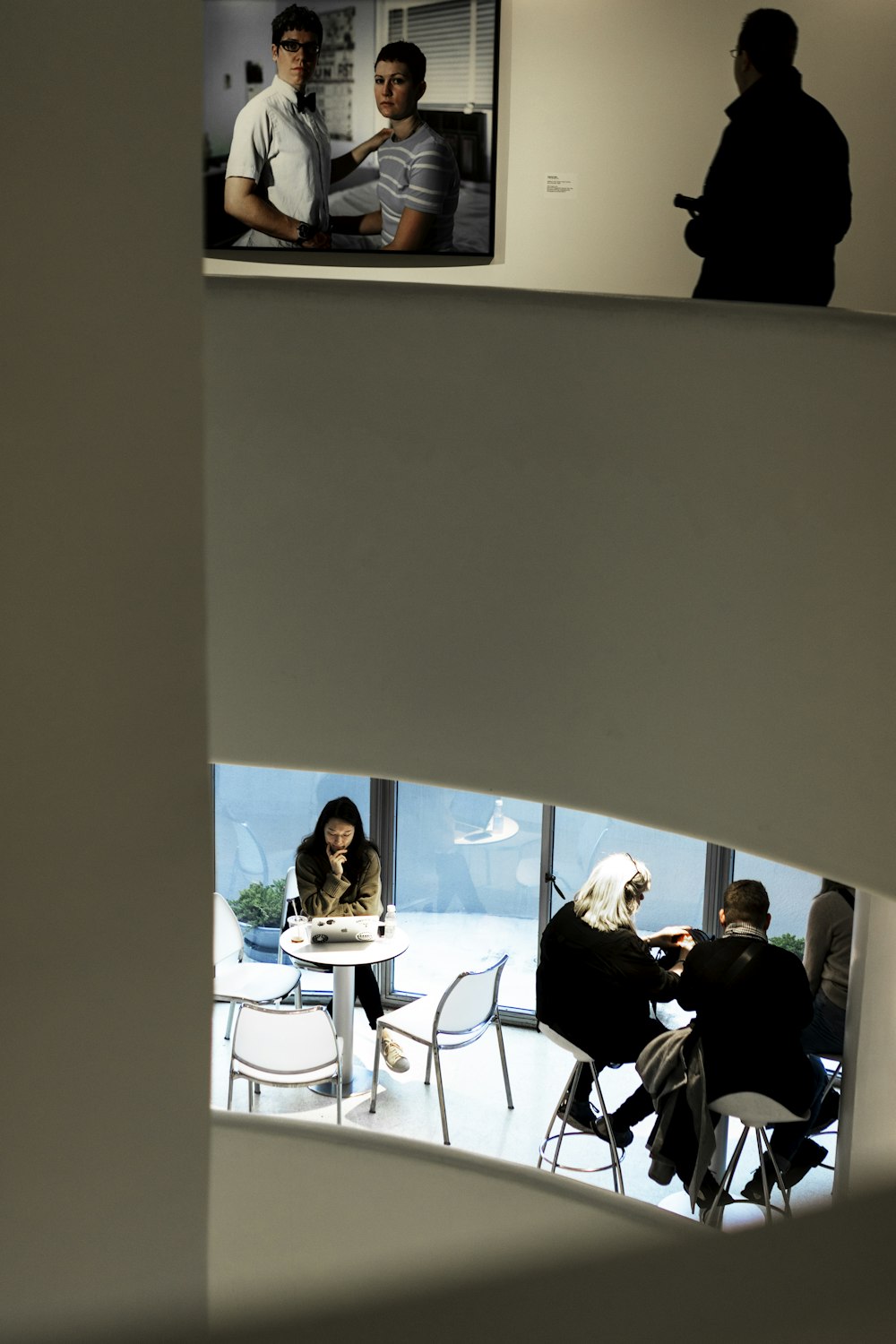 people sitting on chair in front of table