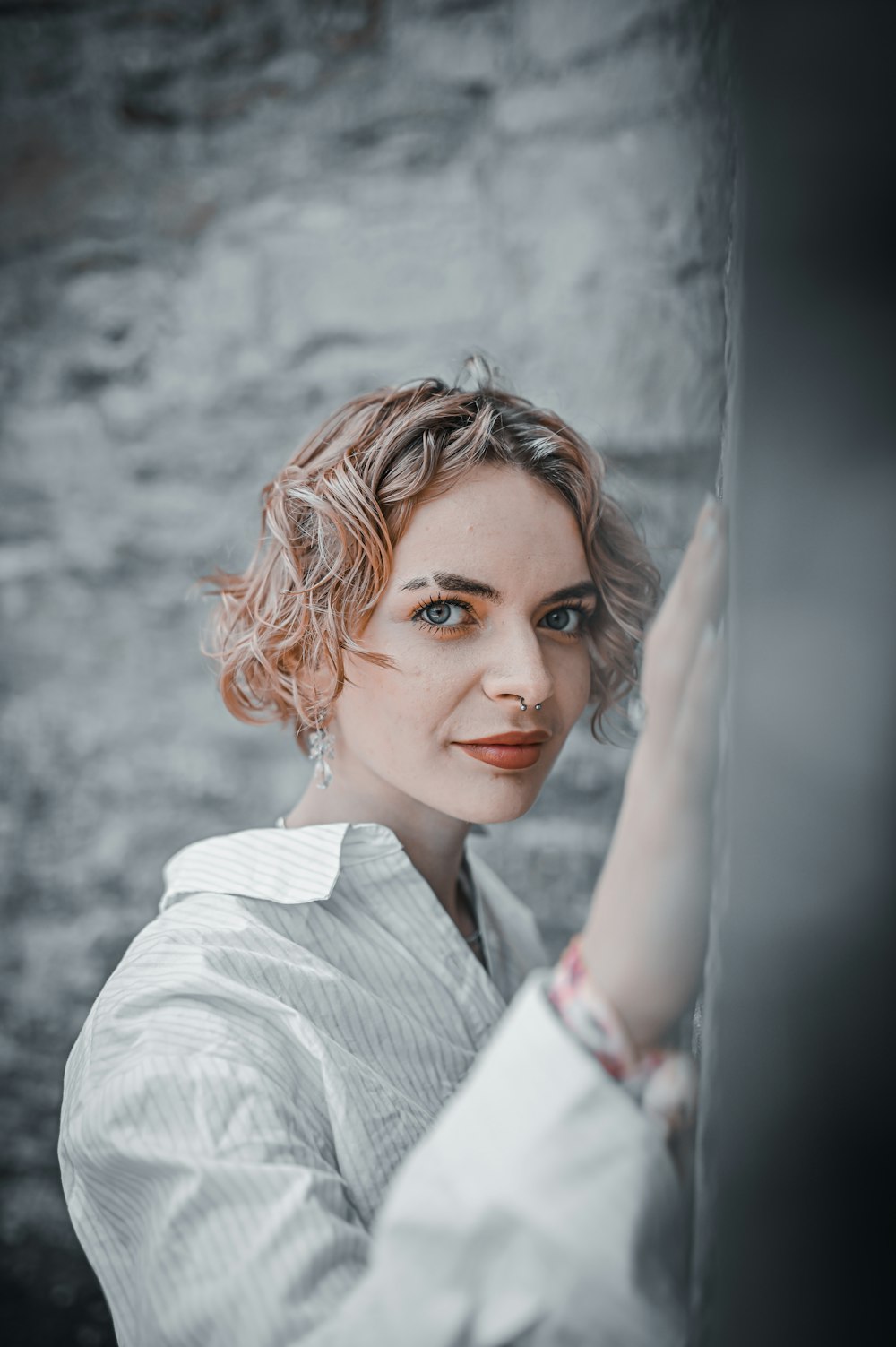 woman in white blazer smiling