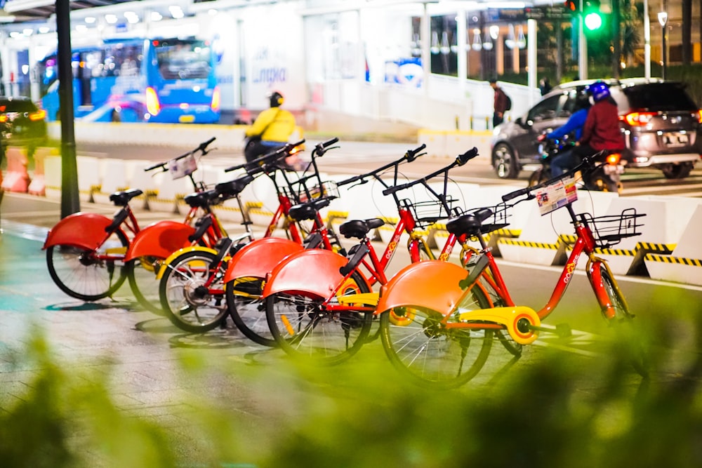 orange bicycles parked on parking lot during daytime