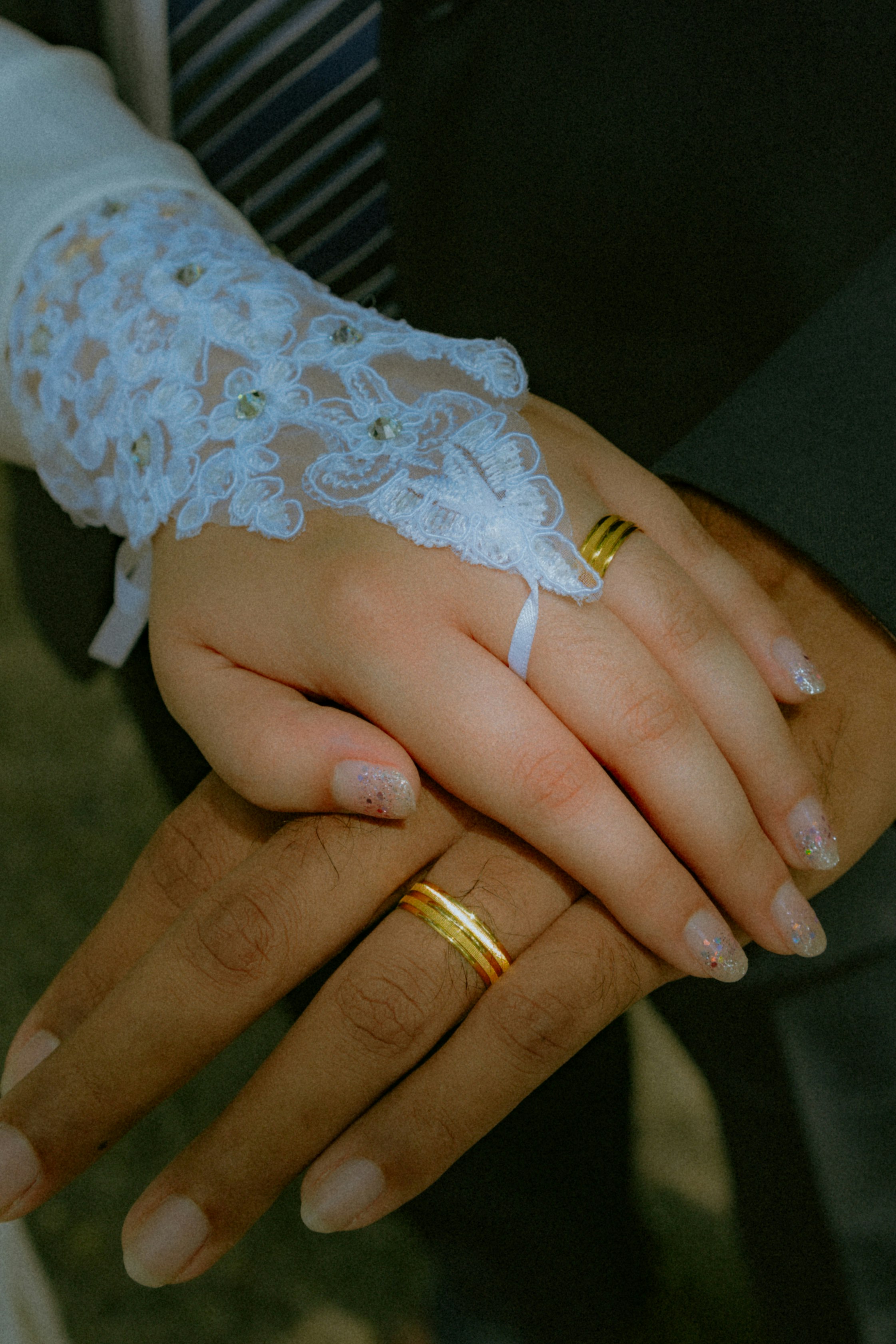 person wearing gold ring with diamond studded