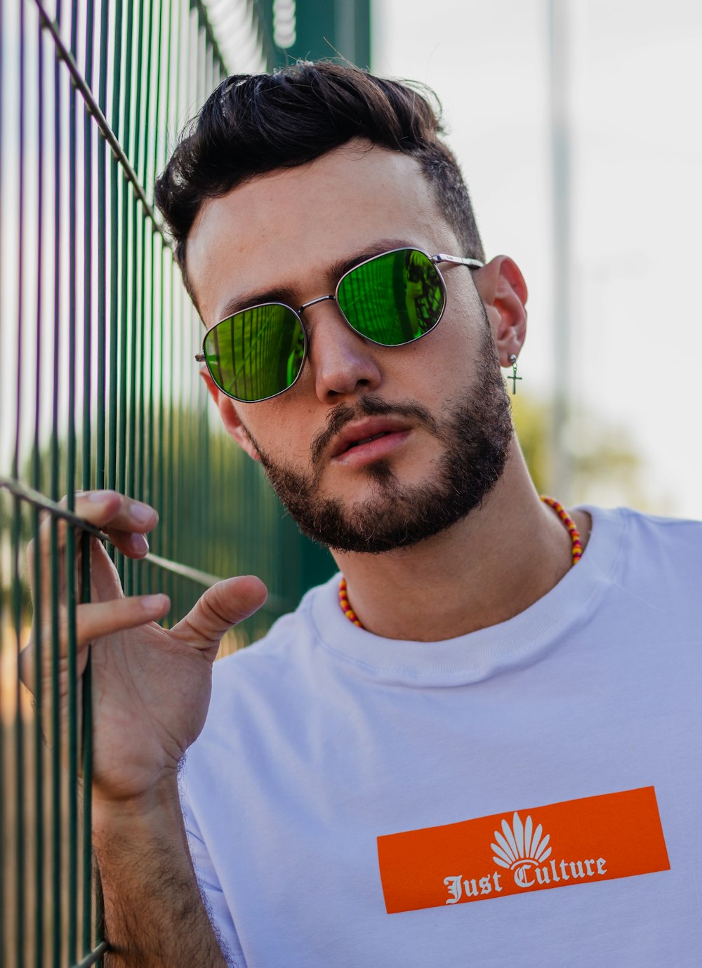 man in white crew neck t-shirt wearing green sunglasses