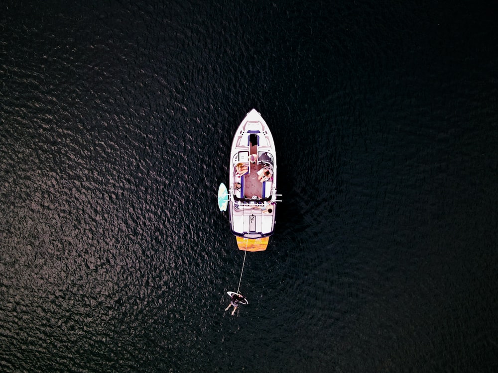 aerial view of white and yellow boat on sea during daytime