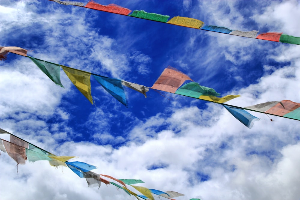 assorted flags under blue and white sunny cloudy sky during daytime