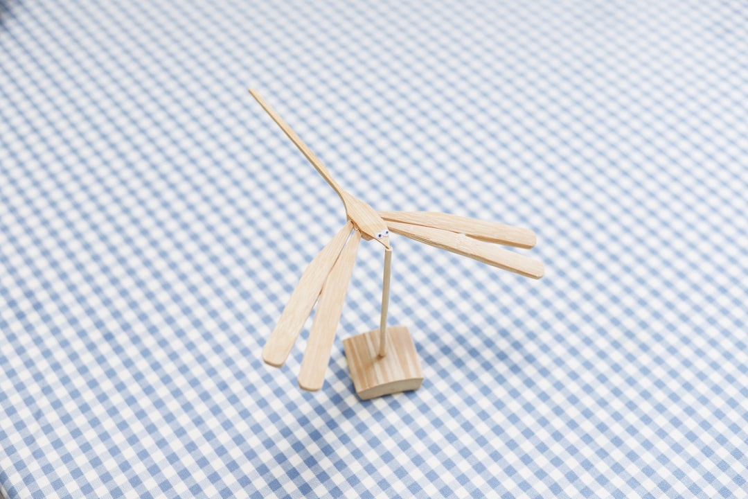 brown wooden clothes pin on white and blue checkered textile