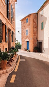 brown concrete building with green plants on the side