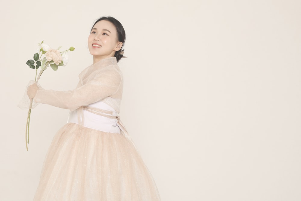 girl in white dress holding white flower