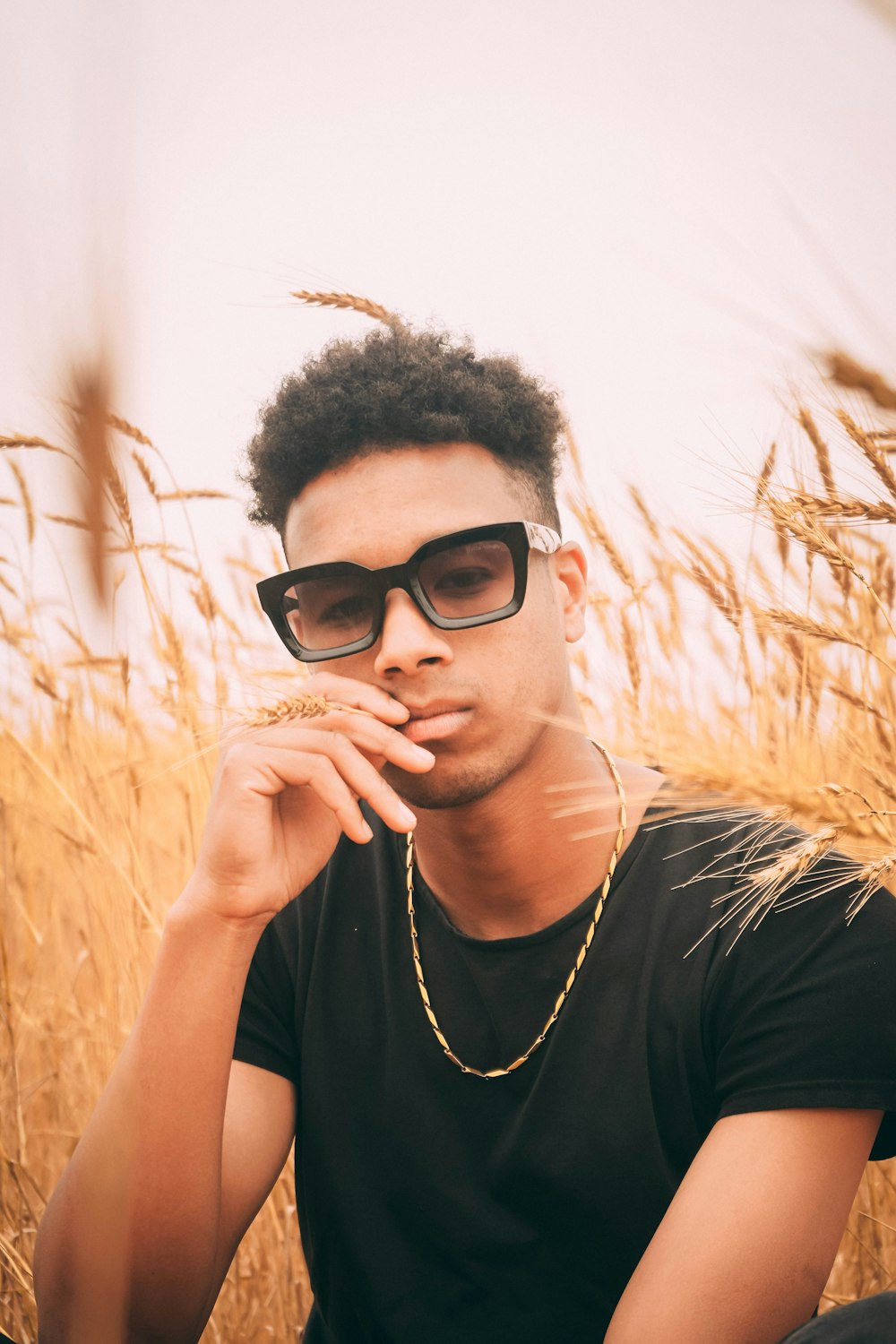 man in black crew neck t-shirt wearing black sunglasses