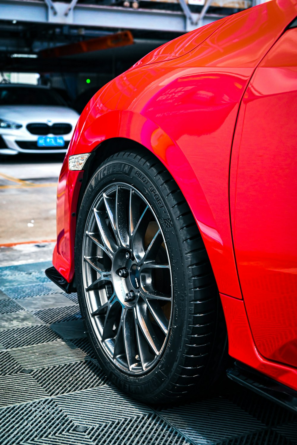 red car on black and white road