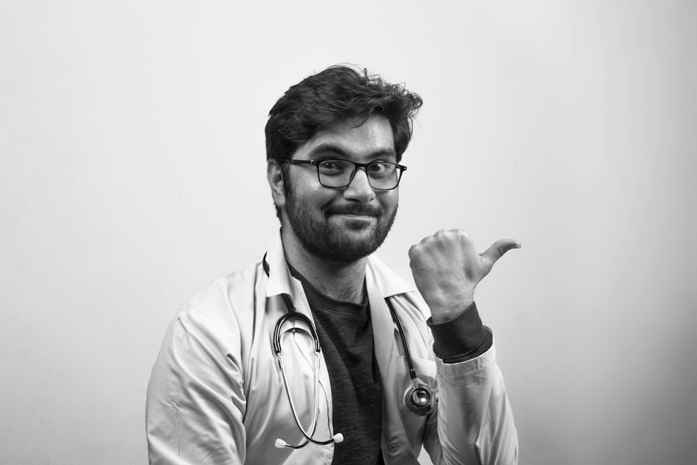 man in white button up shirt wearing black framed eyeglasses