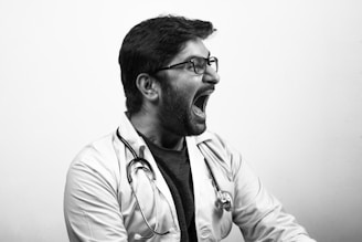 man in white button up shirt wearing black framed eyeglasses