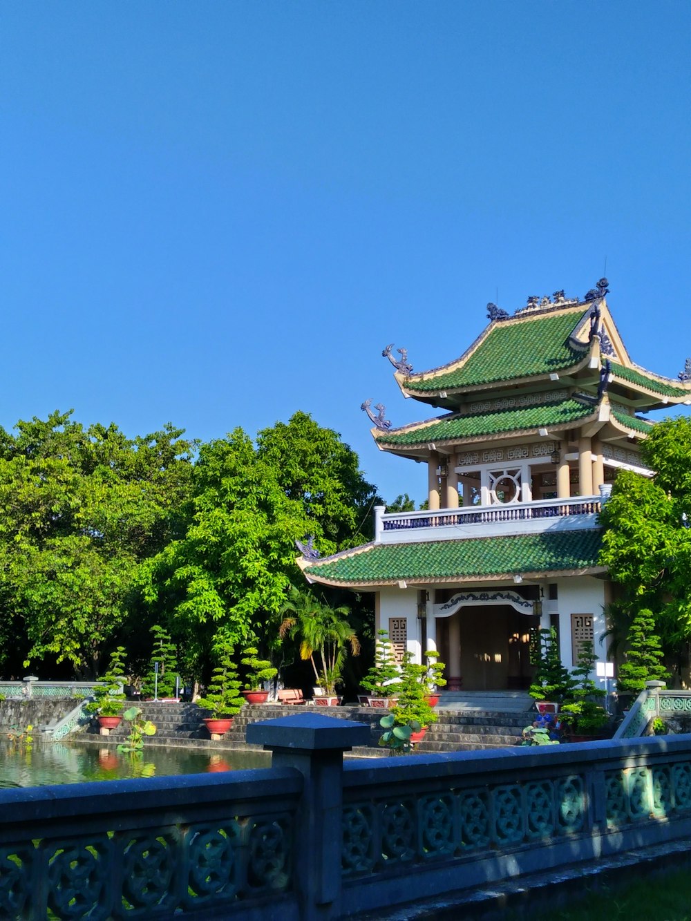 green trees near brown and white temple during daytime