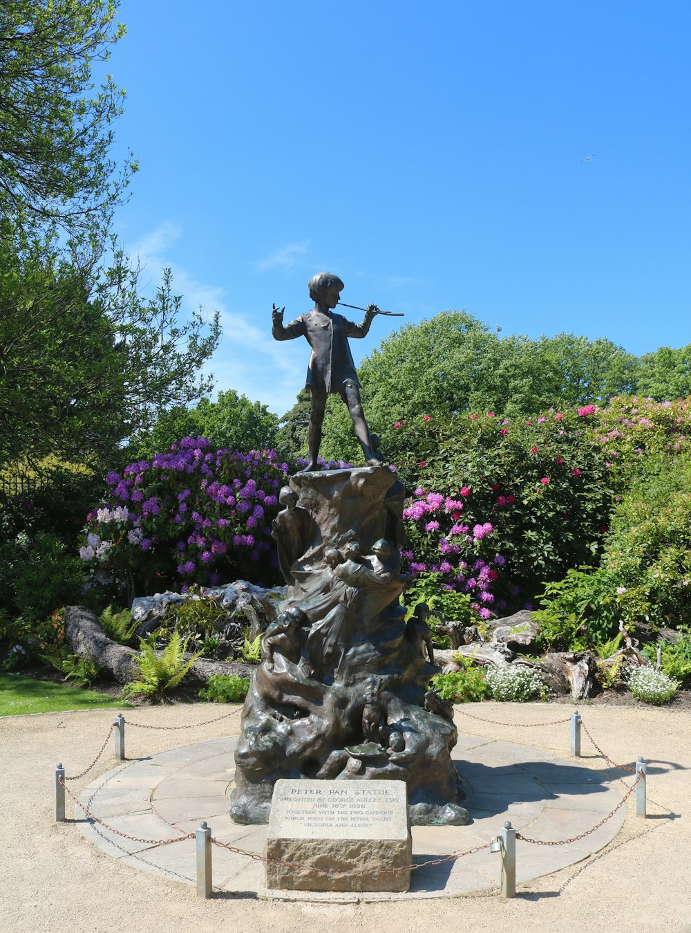 brown statue of man near green trees during daytime