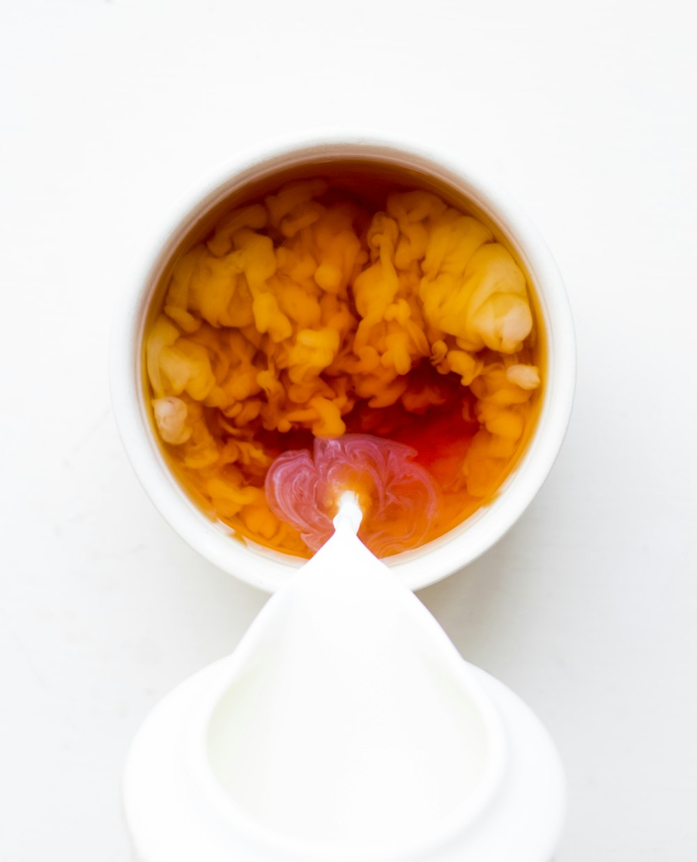 white ceramic bowl with yellow and red food