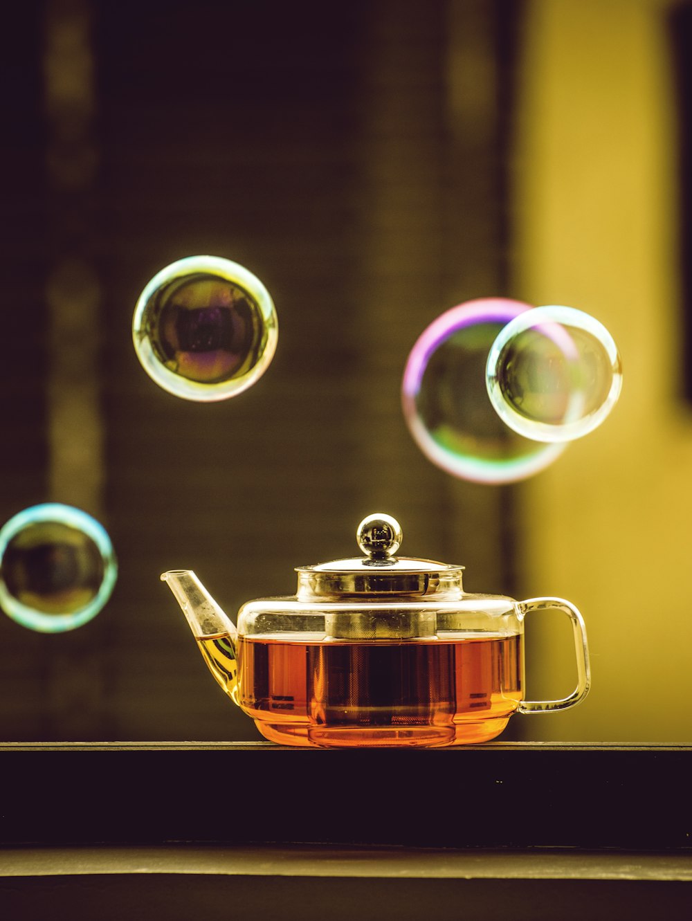 clear glass mug with brown liquid