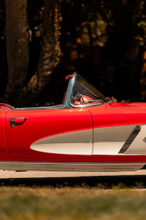 A shiny red convertible with the top down, perfect for a weekend getaway.