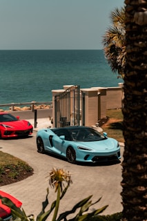 white porsche 911 parked near beach during daytime