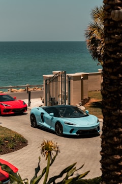 white porsche 911 parked near beach during daytime
