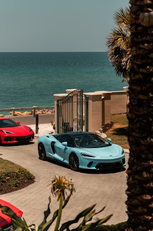 white porsche 911 parked near beach during daytime