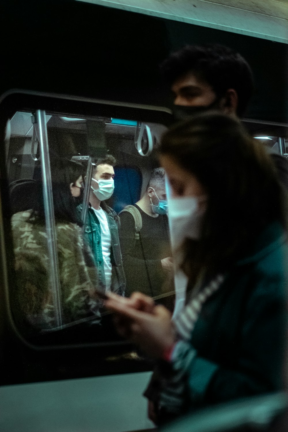 woman in black jacket sitting on bus seat