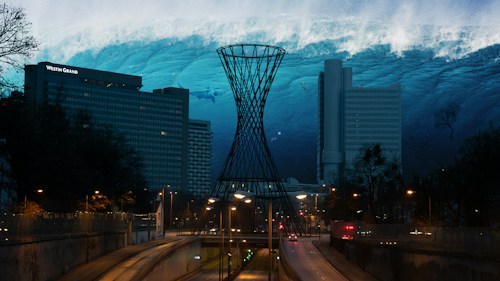 A cityscape blends with a surreal underwater scene where a large wave looms over tall buildings. A futuristic structure appears in the foreground, while trees line the road leading into the city. The scene is illuminated by streetlights, creating an unusual fusion of urban and aquatic environments.
