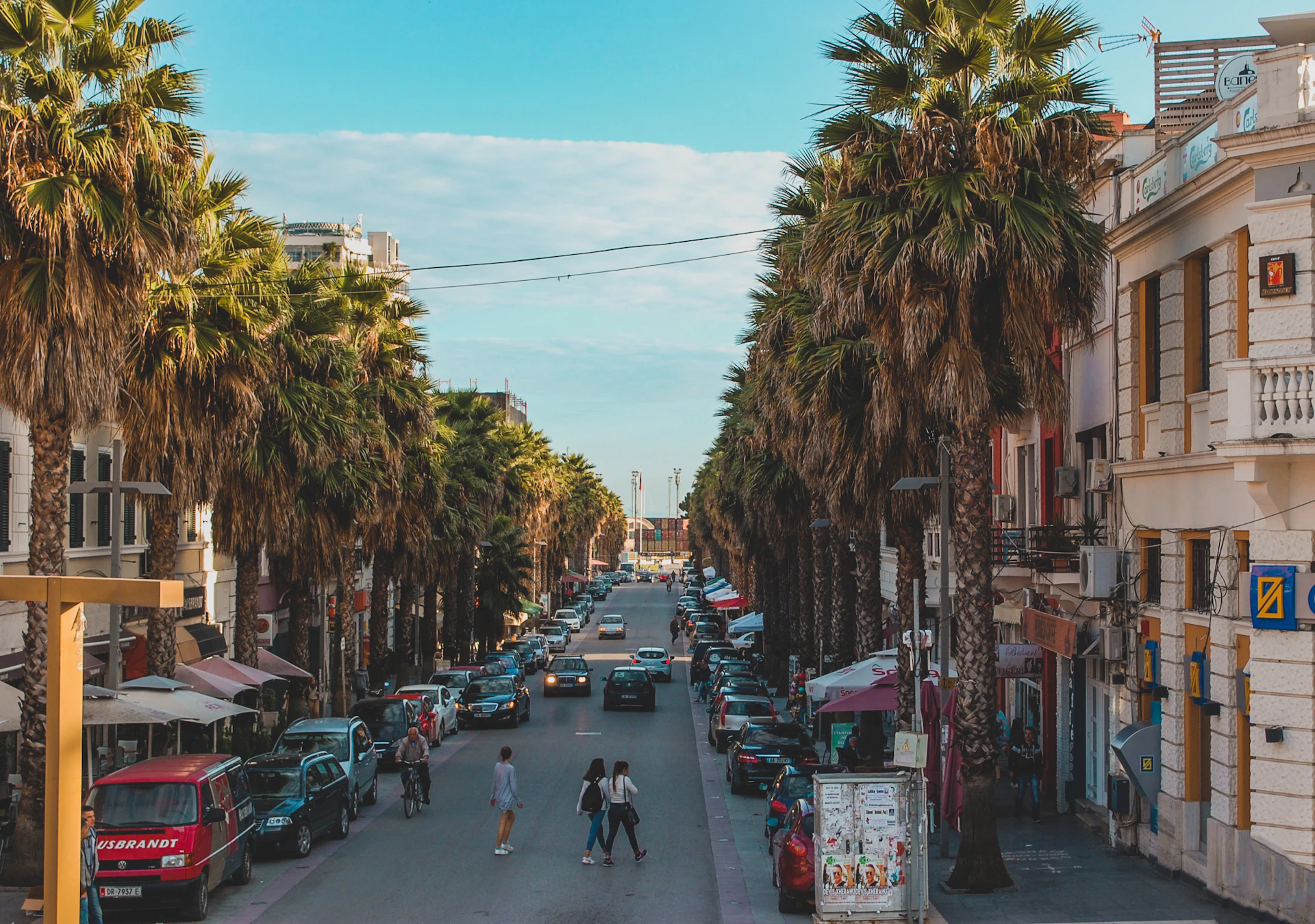 Palm trees and pedestrians along a promenade in Durrës, Albania