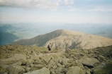 A scenic mountain trail with a hiker sporting durable Solvista sunglasses, enjoying the view.