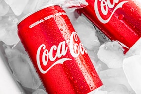 coca cola can on white plastic pack