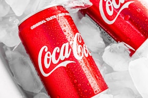 coca cola can on white plastic pack