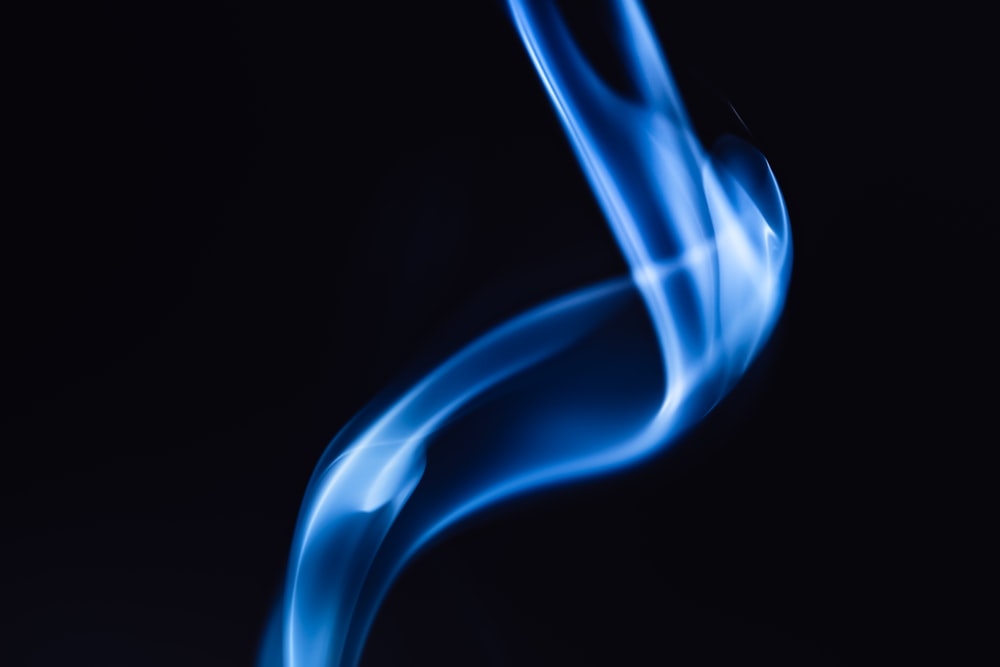 a close up of blue smoke on a black background