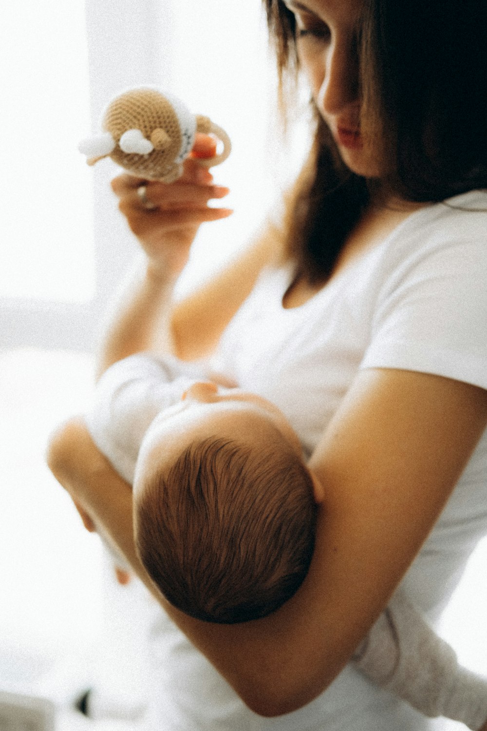 woman in white t-shirt holding baby