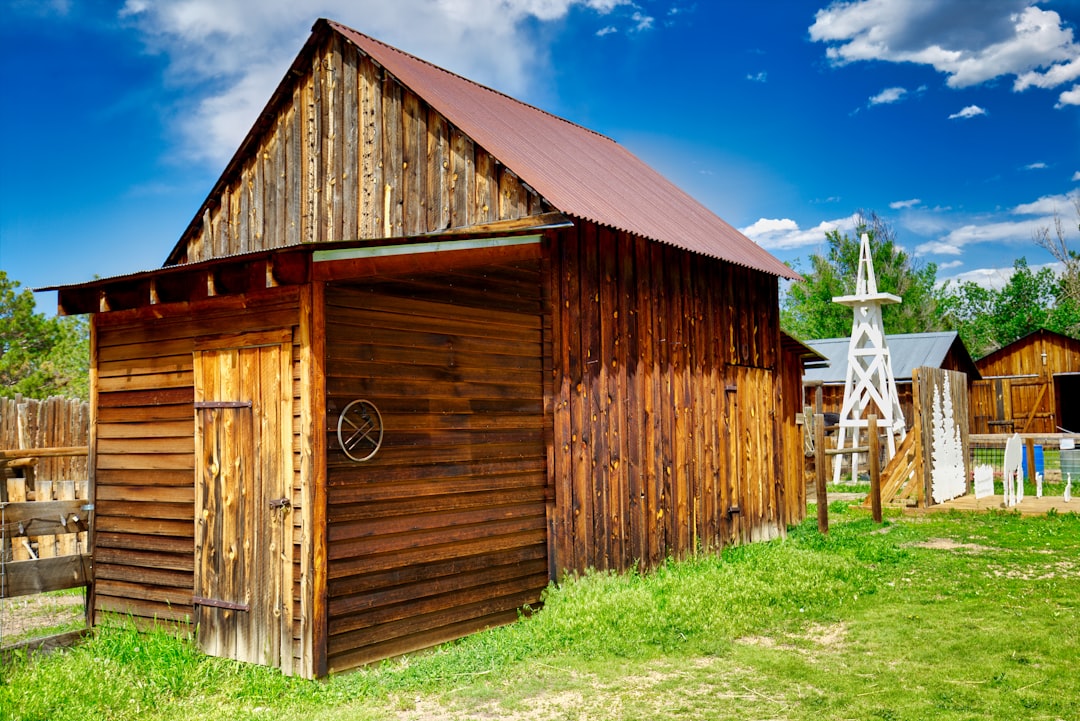brown wooden barn under blue sky during daytime