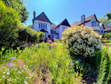 A beautifully landscaped duplex house with vibrant greenery.